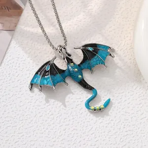 Detail shot of a vintage dragon pendant featuring blue enamel and rhinestone inlay