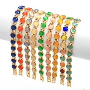 Eleganti bracciali dorati con pietre tonde colorate a occhio di gatto in varie sfumature