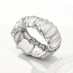 Chunky silver wide bangle featuring an irregular pleated texture design in minimalist style