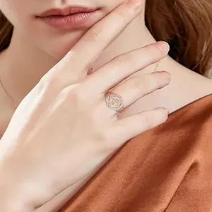 Elegant two-tone cubic zirconia ring with intricate hollow design worn on model's hand