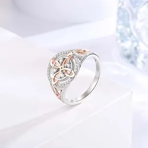Detailed close-up of elegant two-tone Celtic knot ring with sparkling zircon stones