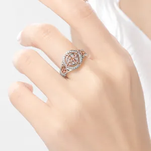Elegant two-tone Celtic knot ring set with sparkling zircon stones on female hand