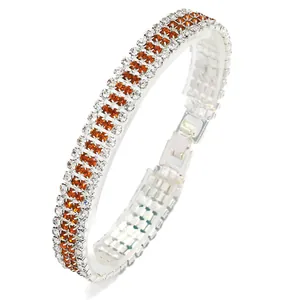 Elegant three-row crystal bracelet featuring amber and clear rhinestones on silver metal