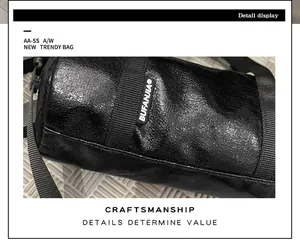 Detailed view of glossy black mini crossbody bag showing premium craftsmanship and texture