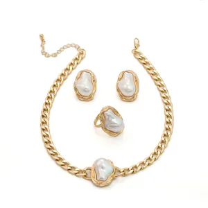 Vintage gold jewelry set featuring irregular baroque pearls: necklace, earrings, and ring.