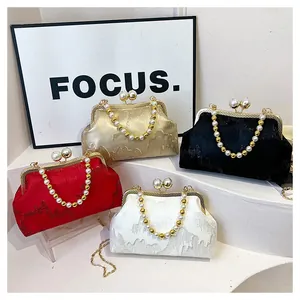 Detailed view of four elegant beaded clasp purses in gold, black, red, and white.