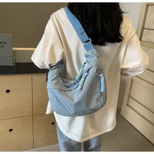 Casual blue dumpling crossbody bag for women, showing large capacity and braided zipper detail