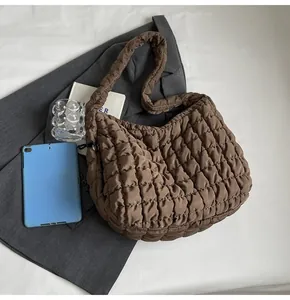 Close-up detail of a brown bubble quilted shoulder bag with a soft textured finish