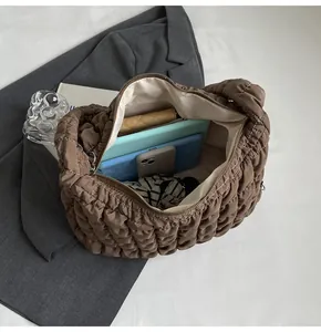 Detailed view of large capacity quilted bubble tote bag showing interior storage space.