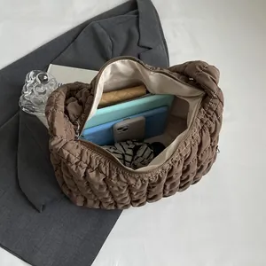 Large capacity brown quilted bubble tote bag showing spacious interior with tablet