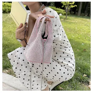 Stylish pink rhinestone bucket bag with silver chain strap for women's trendy fashion outfit
