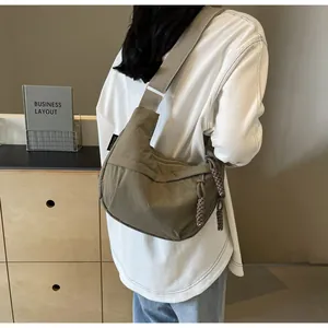 Back view of a casual khaki canvas dumpling bag showing large capacity for daily commuting