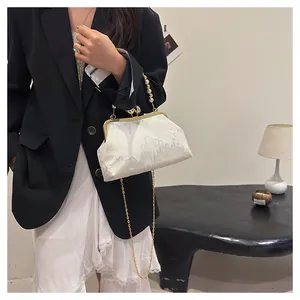 Detailed view of white embroidered New Chinese style beaded clutch bag with gold chain