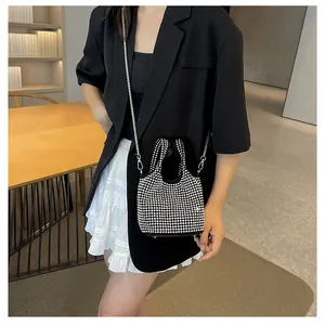 Detailed view of an elegant black rhinestone bucket bag with a silver chain strap and handle
