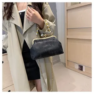 Elegant black sequined kiss-lock handbag with faux pearl handle and gold chain strap