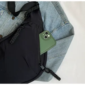 Close-up of black crossbody dumpling bag featuring a functional side zipper pocket.