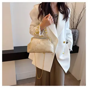 Elegant Neo-Chinese champagne embroidered frame bag featuring pearl handle and gold chain strap