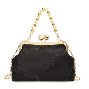 Elegant black sequined kiss-lock evening bag with pearl handle and detachable gold chain