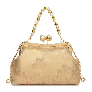 Elegant champagne gold sequined handbag with pearl beaded handle and detachable chain strap