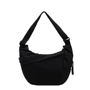 Durable black canvas crescent shoulder bag with adjustable strap and rope zippers