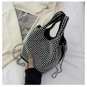Detail of a black bucket bag with sparkling silver rhinestone embellishments