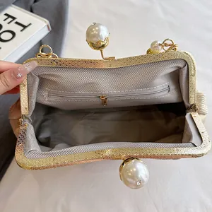 Interior view of an elegant pearl clasp handbag with chevron lining and gold chain