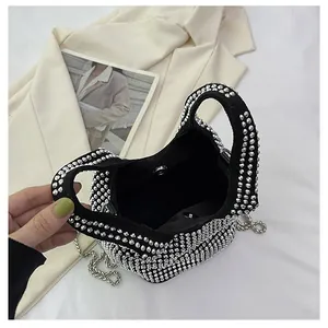 Detailed view of black rhinestone bucket bag with shiny crystals and silver chain