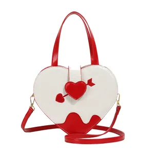Fashionable white and red heart-shaped handbag with crocodile skin texture and arrow applique