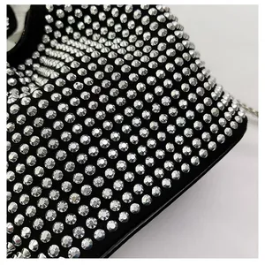 Close-up detail of a women's black bucket bag with sparkling silver rhinestones