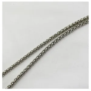 Detailed macro view showing the intricate weave of the silver metallic handbag chain