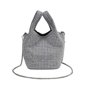 Fashionable silver rhinestone bucket bag with shimmering studs and elegant chain strap