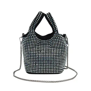 Black bucket bag fully covered with iridescent rhinestones and silver chain strap