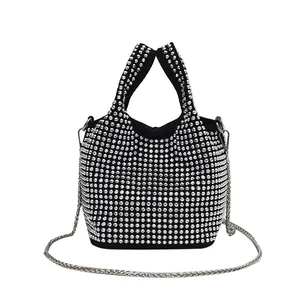 Detailed view of an elegant black bucket bag covered in sparkling silver rhinestones