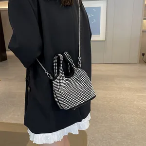 Elegant black rhinestone bucket bag with silver chain strap for women's fashion.