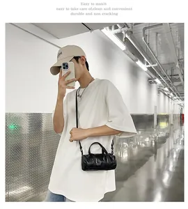 Model wearing a stylish black mini crossbody bag with a casual white t-shirt outfit