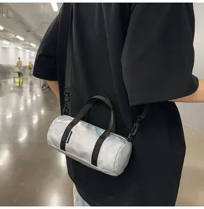 Detailed back view of a person wearing an iridescent mini cylindrical crossbody bag