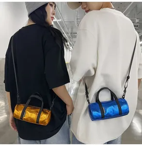 Two models wearing stylish mini metallic cylinder crossbody bags in gold and blue.