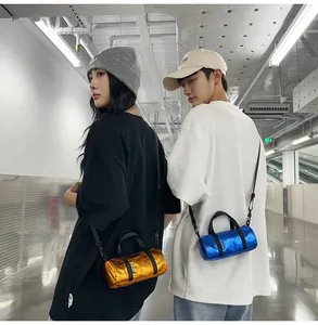 Detail of metallic blue and gold mini barrel crossbody bags worn by models in street style