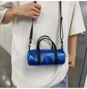 Mini metallic blue cylinder crossbody bag with black adjustable straps for casual sports use