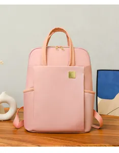 Front view of stylish pink large capacity square backpack on a wooden table