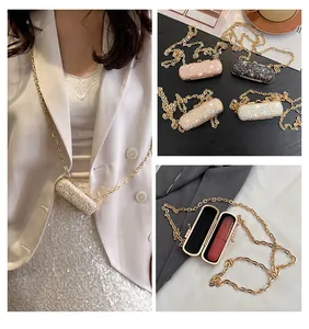 Detailed views of the glittery mini lipstick chain bag for elegant evening parties.