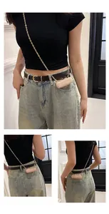 Detailed view of sequin mini lipstick bag with elegant gold chain strap on model.
