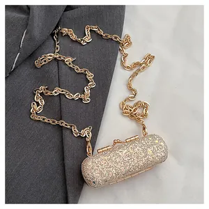 Close-up detail of a sparkling mini glitter lipstick bag with an elegant gold chain strap