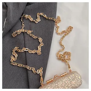 Detailed view of a mini evening bag featuring sparkling glitter and a gold chain strap