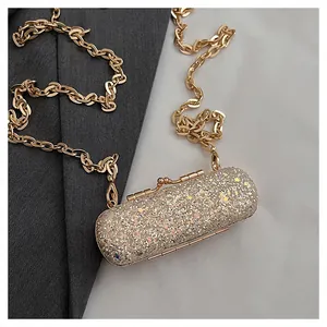 Close-up showing the shimmering glitter texture and golden chain of this mini lipstick bag