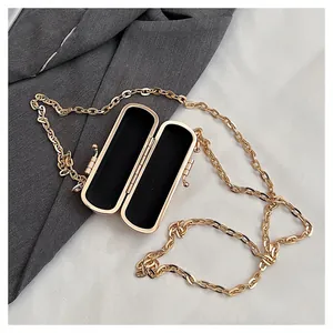 Interior detail of a stylish mini lipstick bag with golden chain for evening parties.