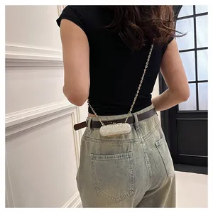 Rear view of a fashionable silver sequin mini evening bag with a gold chain strap