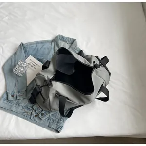 Detailed interior view showing the spacious storage of a gray travel duffel bag