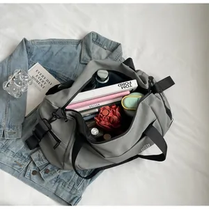 Spacious grey travel duffel bag with organized interior for short trip storage.
