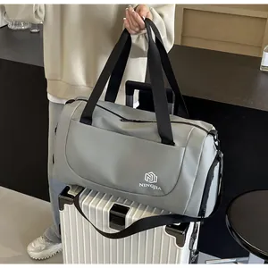 Versatile large capacity grey travel duffel bag shown on a white suitcase for travel